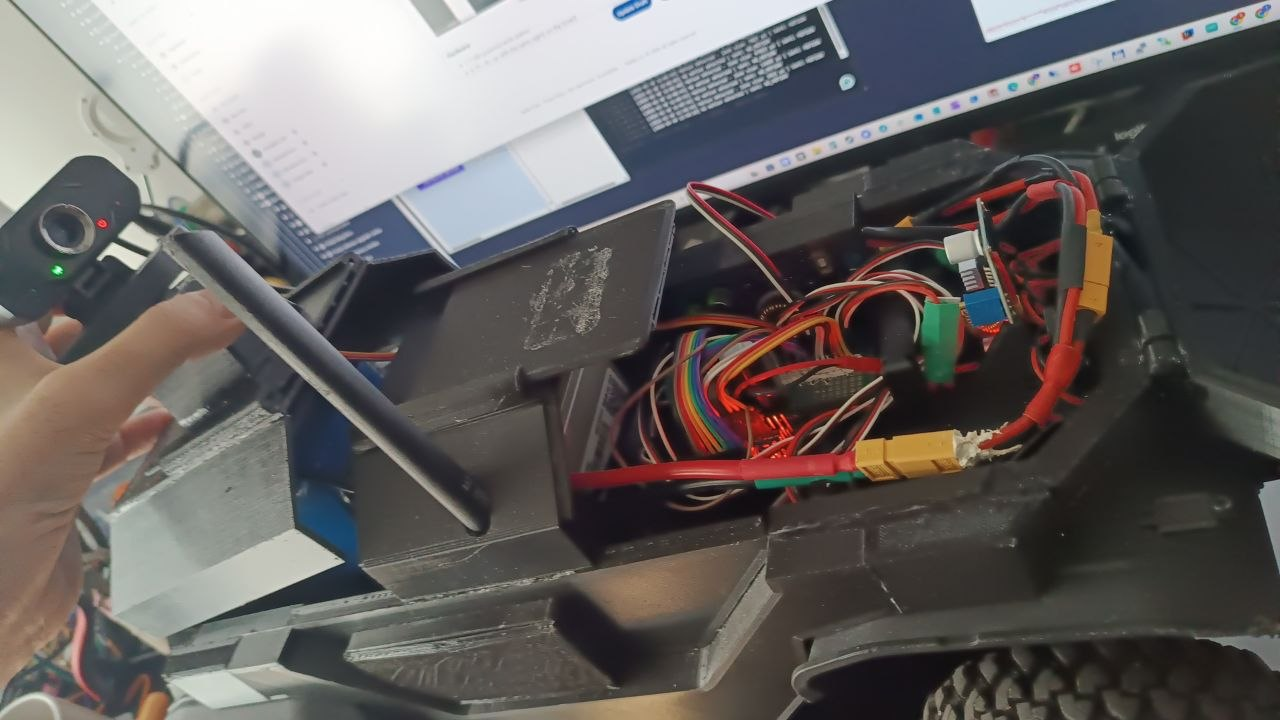 Open RC car chassis with embedded controller, wiring and radio hardware used in the Python ML control prototype